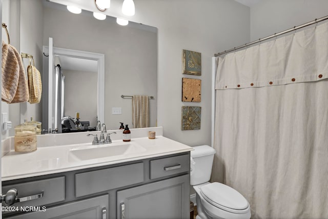 bathroom featuring toilet and vanity