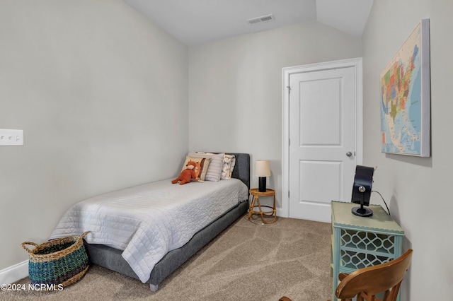 bedroom featuring light carpet and lofted ceiling