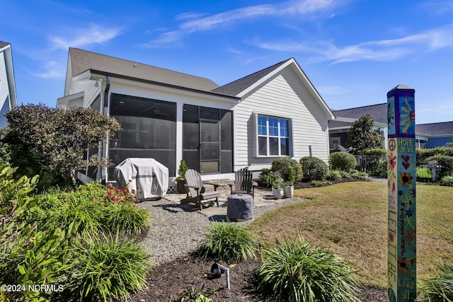 4422 Old Towne St, Wilmington, NC 28412 - back of house with a sunroom, a yard, and a shingled roof