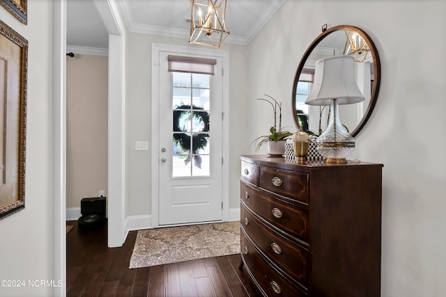 foyer featuring ornamental molding, an inviting chandelier, and dark hardwood / wood-style flooring