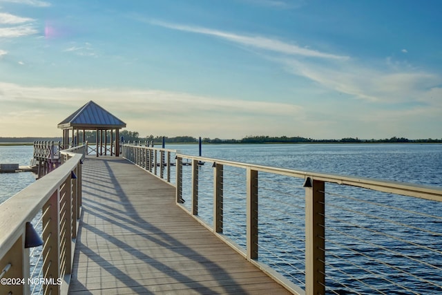 view of dock with a gazebo and a water view