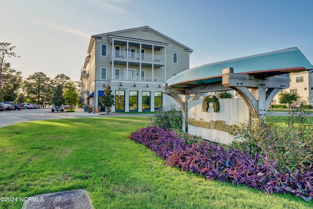 exterior space featuring a yard and a balcony