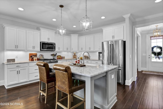 4422 Old Towne St, Wilmington, NC 28412 - kitchen with a chandelier, a kitchen island, white cabinets, and stainless steel appliances