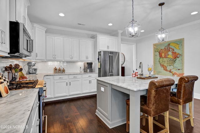 kitchen featuring white cabinets, high quality appliances, a center island, and dark hardwood / wood-style floors