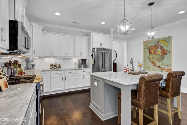 4422 Old Towne St, Wilmington, NC 28412 - kitchen featuring high end appliances, decorative backsplash, white cabinets, and dark wood-type flooring