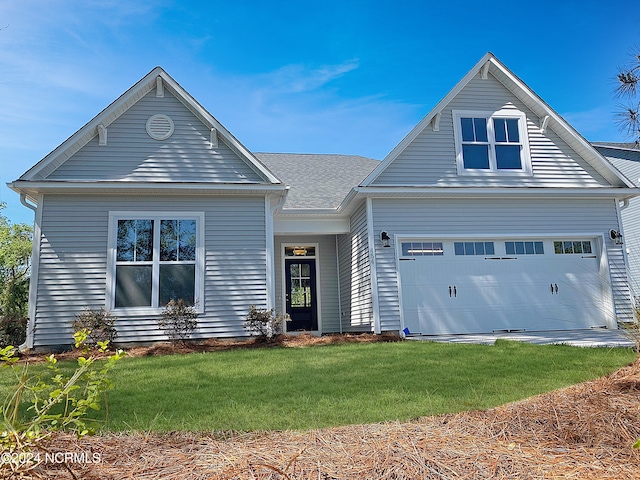 view of front of house with a front yard and a garage