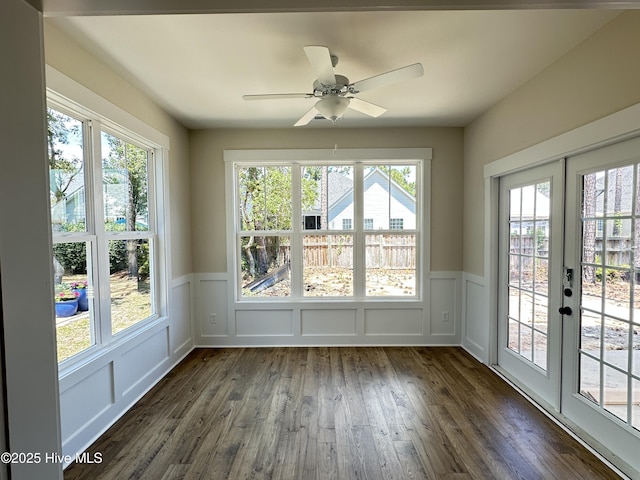 3965 Pepperberry Ln, Southport, NC 28461 - unfurnished sunroom featuring french doors, healthy amount of natural light, wood finished floors, a wainscoted wall, and a decorative wall