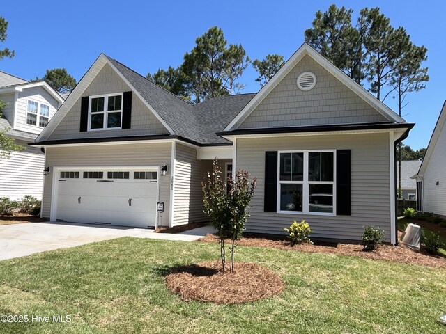 3965 Pepperberry Ln, Southport, NC 28461 - view of front of house with a front yard, concrete driveway, a garage, and a shingled roof
