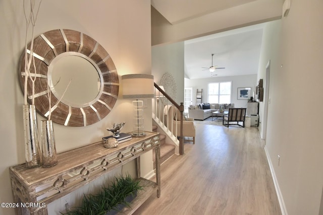 3965 Pepperberry Ln, Southport, NC 28461 - hallway with wood finished floors, stairway, and vaulted ceiling