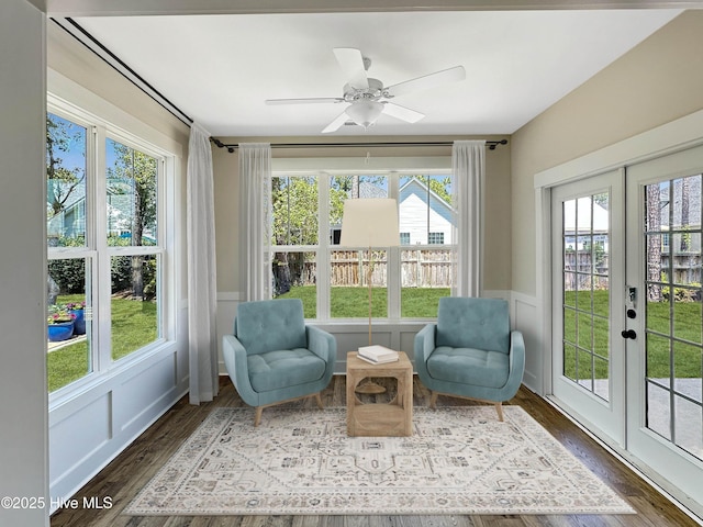 3965 Pepperberry Ln, Southport, NC 28461 - sunroom / solarium with french doors, a wainscoted wall, wood finished floors, and a decorative wall