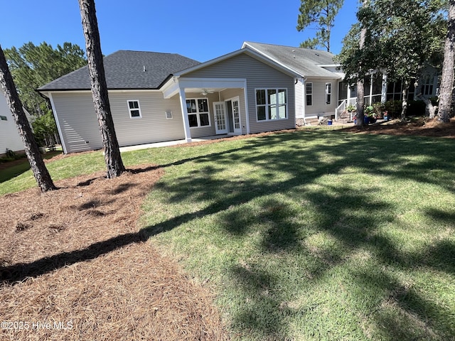 3965 Pepperberry Ln, Southport, NC 28461 - rear view of property featuring ceiling fan, a yard, and a shingled roof