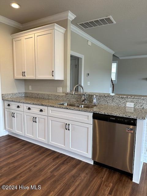 kitchen with dishwasher, white cabinetry, and sink