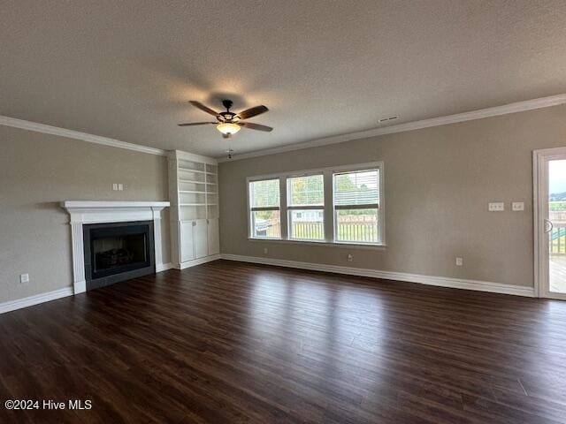 unfurnished living room with ceiling fan, dark hardwood / wood-style floors, crown molding, and a textured ceiling