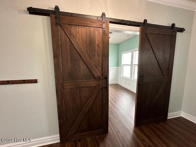 interior space featuring hardwood / wood-style flooring and a barn door