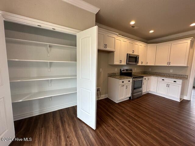 kitchen featuring dark wood-type flooring, white cabinets, and stainless steel appliances