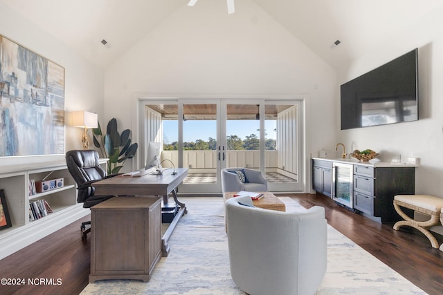 living room featuring wine cooler, high vaulted ceiling, wood-type flooring, and sink