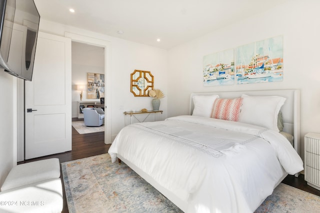 bedroom with dark hardwood / wood-style flooring