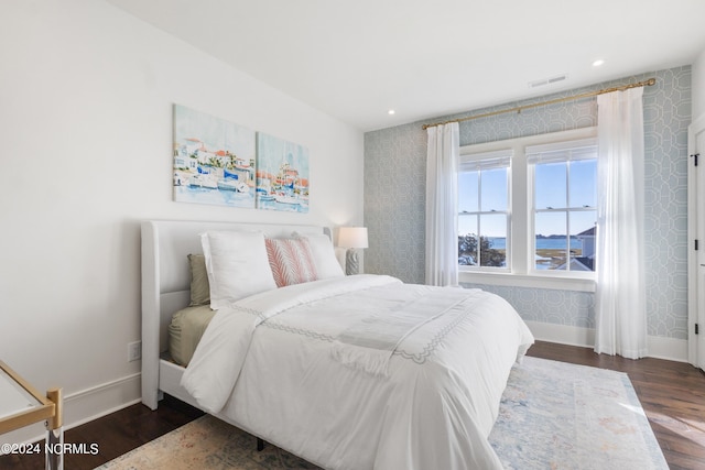 bedroom with dark wood-type flooring