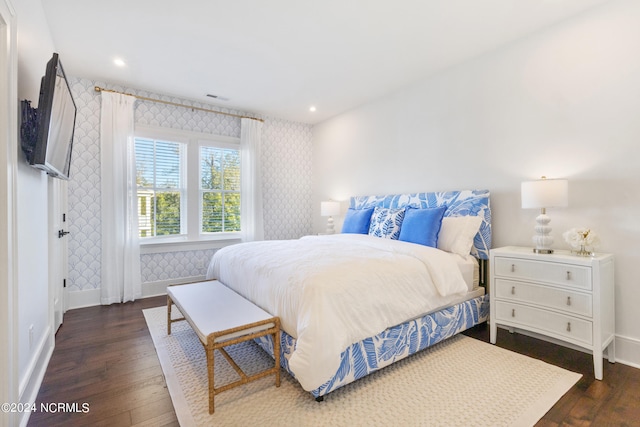 bedroom with dark hardwood / wood-style flooring