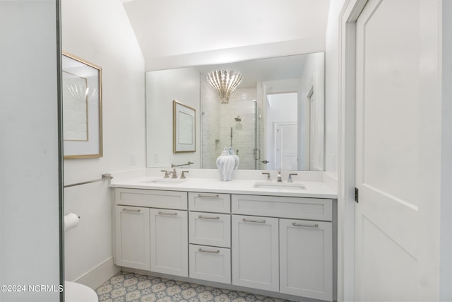 bathroom featuring vanity, a notable chandelier, and an enclosed shower