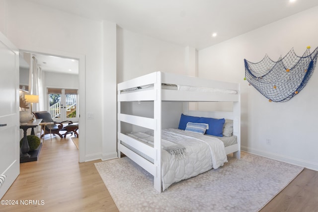 bedroom with french doors and light wood-type flooring