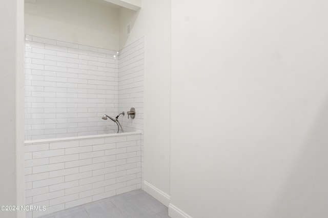 bathroom featuring tile patterned floors and tiled shower