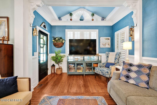 living room with hardwood / wood-style flooring and vaulted ceiling