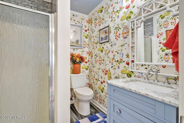 bathroom featuring hardwood / wood-style flooring, toilet, a shower with shower door, vanity, and crown molding