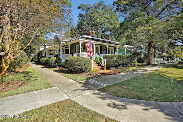 bungalow with covered porch and a front yard