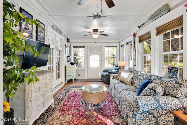 sunroom / solarium featuring ceiling fan