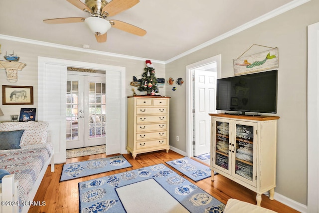 living room with light hardwood / wood-style flooring, french doors, crown molding, and ceiling fan