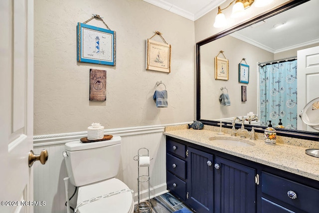 bathroom featuring vanity, ornamental molding, and toilet