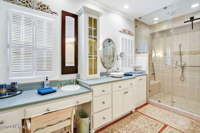 bathroom with vanity, ornamental molding, and walk in shower