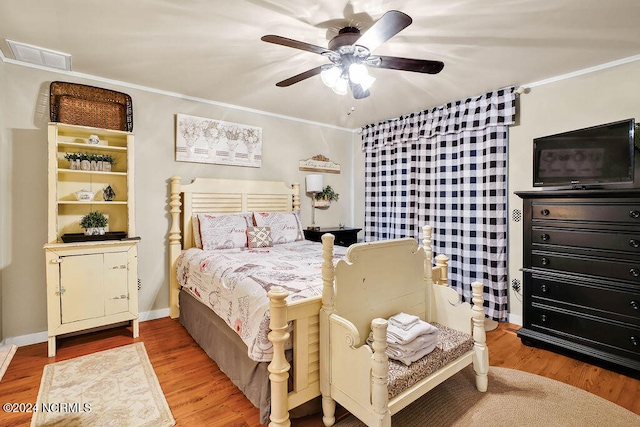 bedroom featuring crown molding, hardwood / wood-style floors, and ceiling fan