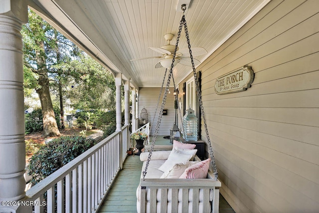 wooden terrace with a porch and ceiling fan