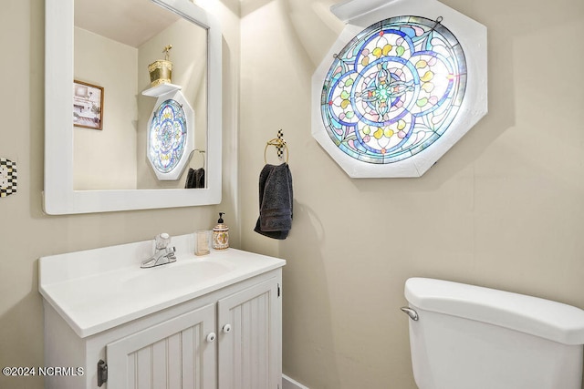 bathroom with toilet and vanity