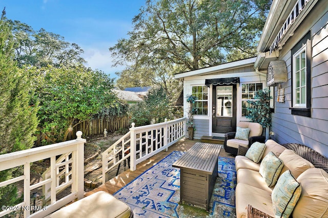 wooden terrace with an outdoor living space