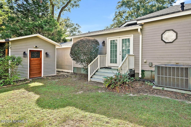 exterior space with a storage shed, central air condition unit, and a lawn