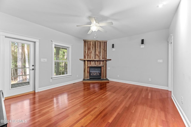 unfurnished living room with light wood-type flooring and ceiling fan