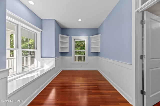 empty room featuring dark hardwood / wood-style floors and plenty of natural light