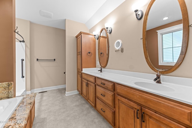 bathroom with vanity and a bath