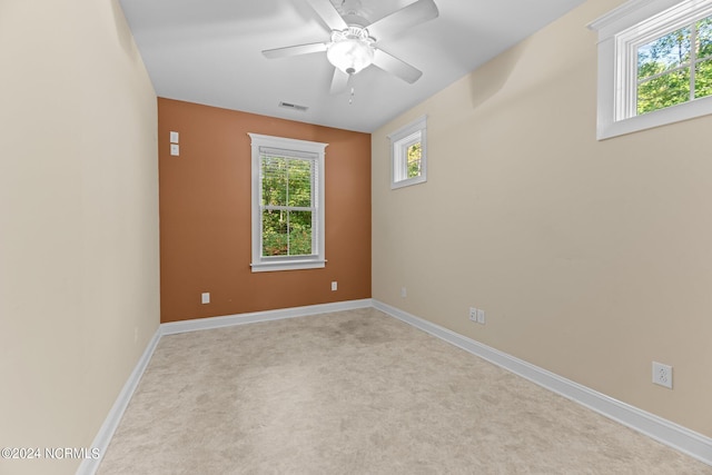 unfurnished room featuring light carpet and ceiling fan