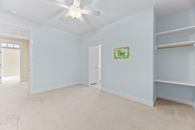 unfurnished bedroom featuring light colored carpet and ceiling fan