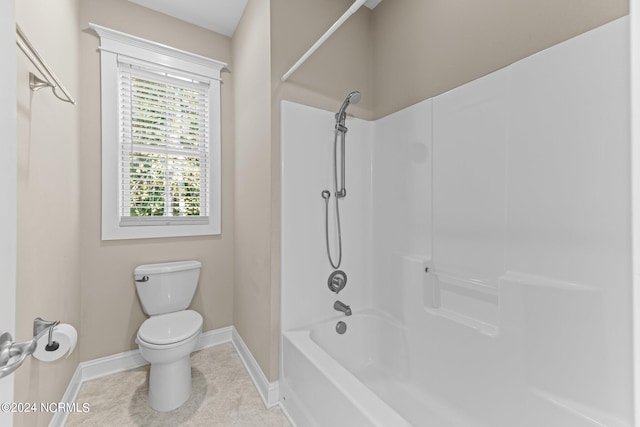 bathroom featuring toilet, tile patterned flooring, and tub / shower combination