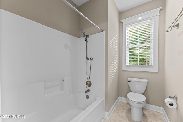 bathroom featuring toilet, tile patterned floors, and shower / bathtub combination