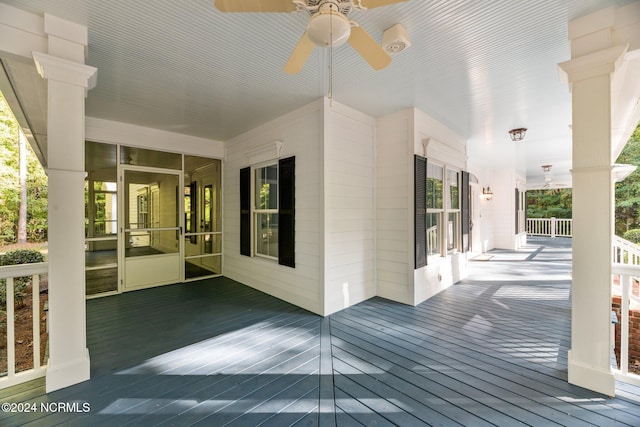 wooden deck featuring a porch and ceiling fan