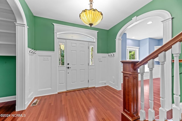 foyer entrance with wood-type flooring and plenty of natural light