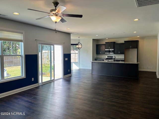 unfurnished living room featuring dark hardwood / wood-style floors, sink, and ceiling fan