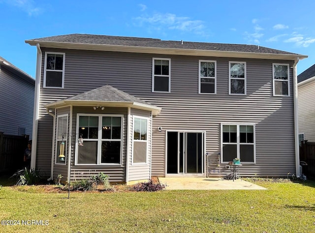 rear view of house with a patio area and a yard