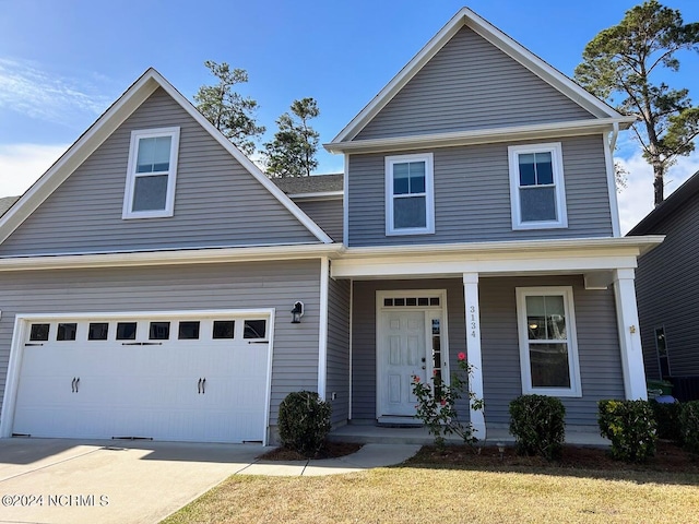 view of front of house with a porch, a front lawn, and a garage